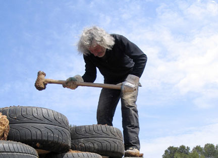 michael_reynolds_02_w Architect Michael Reynolds Pounds Tires - From the film Garbage Warrior by Oliver Hodge