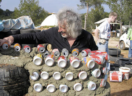 michael_reynolds_04_w Architect Mike Reynolds works on a Can Wall - New Mexico - From the film Garbage Warrior by Oliver Hodge